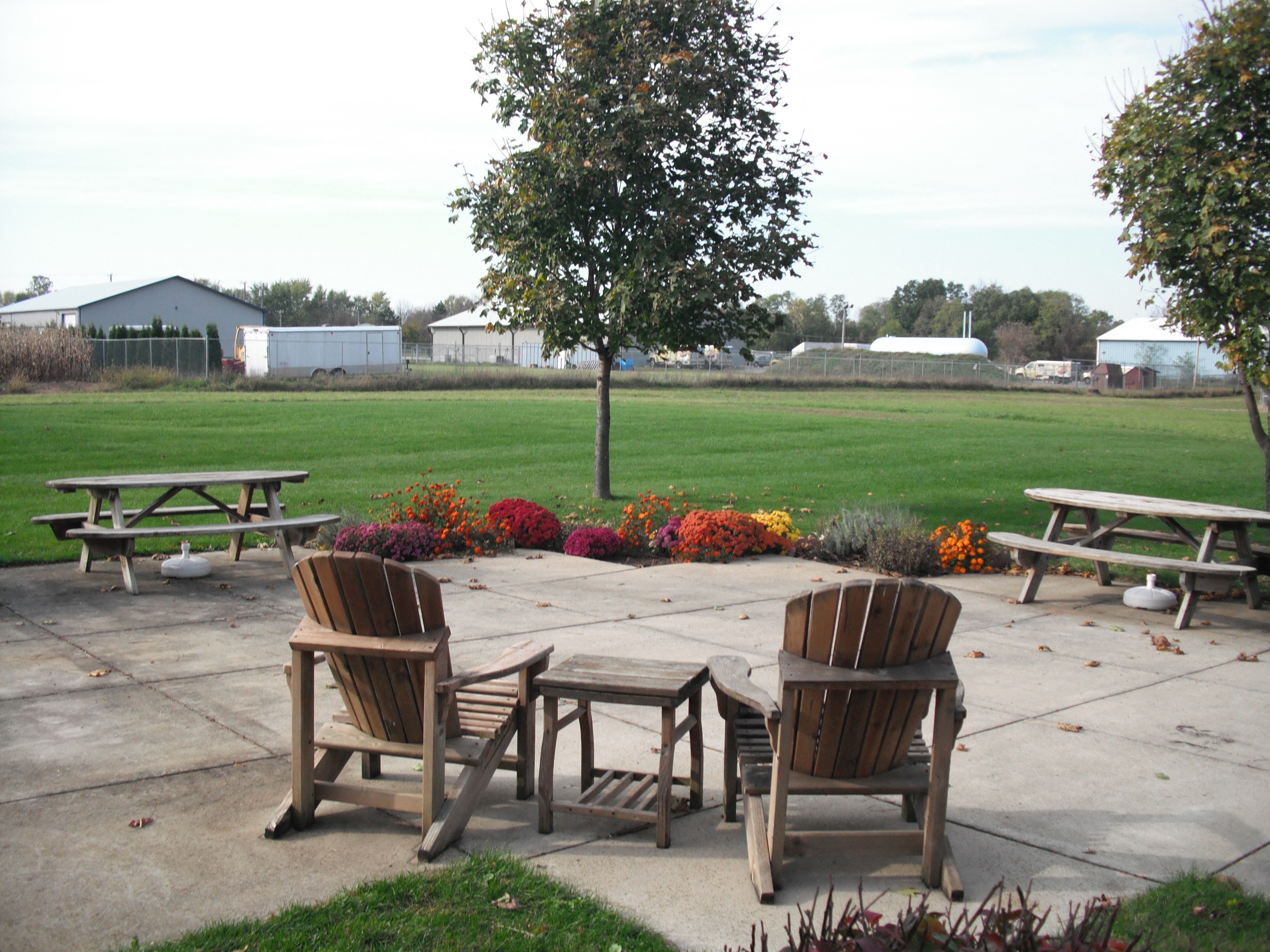 a patio with chairs and tables in a park